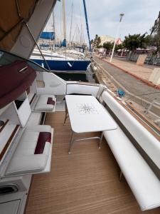 a boat with a table and a bench on a dock at Sunset boat in Leucate-Plage +12 photos