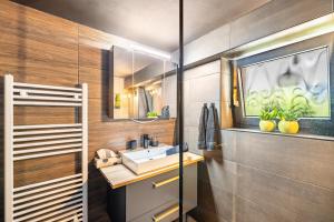 a bathroom with a sink and a mirror at Fewo Abendruh in Elzach +27 photos