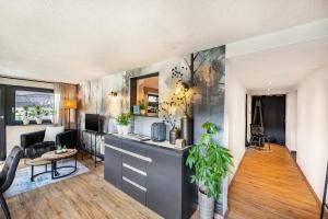 an open living room with a kitchen and a living room at Fewo Abendruh in Elzach