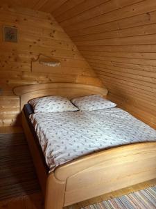 a bed in a wooden room in a cabin at Jakobihütte in Sankt Margarethen bei Knittelfeld