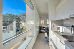 a kitchen with a large window with a view at Casa Cupido Locarno - Happy Rentals in Locarno