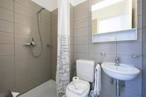 a bathroom with a toilet and a sink at Casa Cupido Locarno - Happy Rentals in Locarno