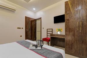 a hotel room with a bed and a desk at Townhouse Hotel Spotlight in Nawābganj