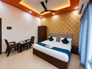 a bedroom with a bed and a table and chairs at Hotel RL Ramayansh - 300 mtr From Ram Mandir Ayodhya in Ayodhya