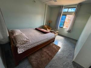 a bedroom with a bed and a window at BeeHive Homestay in Hāflong +16 photos