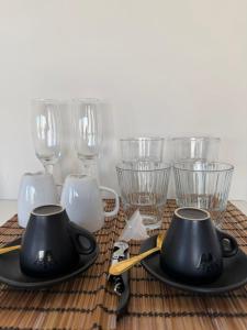 a table topped with black plates and wine glasses at The Athenian Pearl in Athens