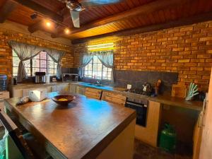 a kitchen with a wooden counter top in a room at Indlovu Inn in Marloth Park