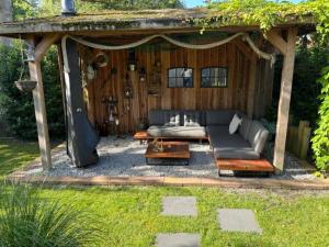a gazebo with a couch and a table at Jeltje in Wildervank