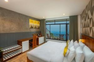 a bedroom with a bed with a desk and a balcony at leisure Mount View in Haputale