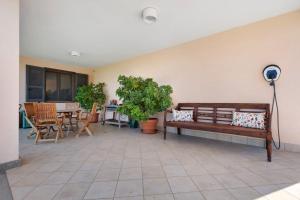 a patio with a bench and a table and chairs at Luxury Apartment Lake View in Bolsena