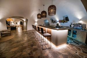 a tasting room with a bar with stools at Rostock Ritz Desert Lodge in Cha-re +101 photos