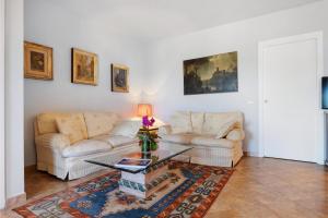 a living room with two couches and a table at Luxury Apartment Lake View in Bolsena +26 photos