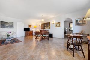 a living room with wooden tables and chairs at Luxury Apartment Lake View in Bolsena