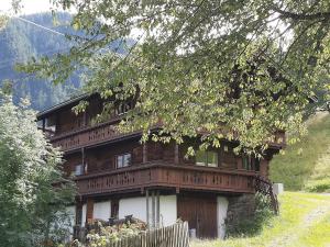 a large wooden house on the side of a hill at Zimmerhäusl in Schlitters