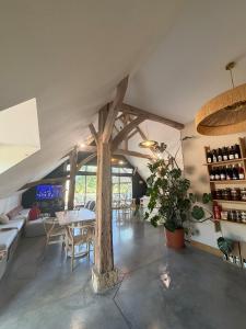 a room with a table and chairs and wine bottles at Les gîtes de la Grange de Léonie - jacuzzis privatifs et Piscine in Vierzon