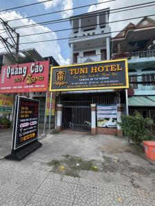 a group of signs in front of a hotel at TUNI Hotel in Long Bình