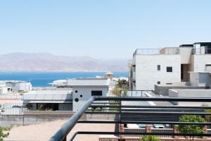 a view of the ocean from a balcony of a building at Villa Lum - BY Harim in Eilat