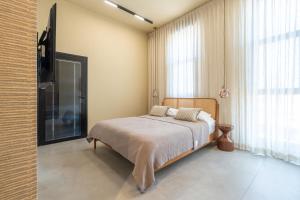a bedroom with a bed and a large window at Villa Lum - BY Harim in Eilat +23 photos