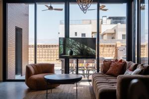 a living room with a couch and a tv at Villa Lum - BY Harim in Eilat