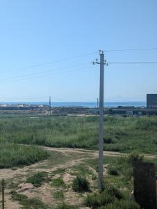 a telephone pole in the middle of a field at Meikin guest house in Chok-Tal +3 photos