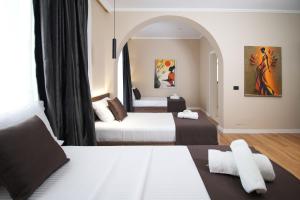 a hotel room with two beds and an archway at Velor Boutique Hotel in Tirana