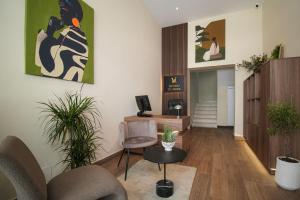 an office with a chair and a desk with plants at Velor Boutique Hotel in Tirana