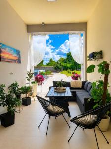 a living room with a couch and some plants at Apartman Ćosić in Kruševica