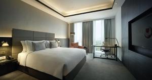 a hotel room with a large bed and a television at G Hotel Kelawai in George Town +41 photos