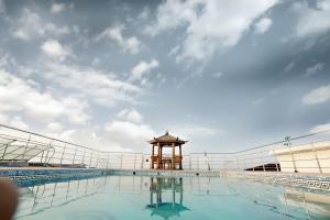 a view of a swimming pool with a gazebo at Hotel Patliputra Continental in Patna