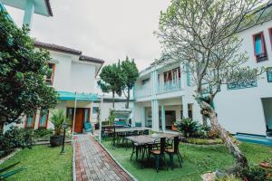 a courtyard of a house with a table and chairs at Aleyra Hotel and Villa's Garut in Garut