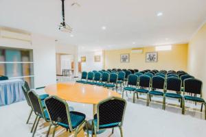 a conference room with a wooden table and chairs at Aleyra Hotel and Villa's Garut in Garut +50 photos