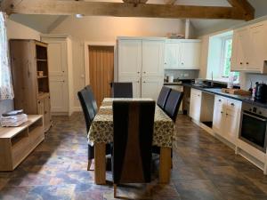 a kitchen with a table and chairs in it at Lodge 1, The Grange in Wick