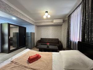 a hotel room with a bed and a couch at Guest House - Avlabari in Tbilisi City