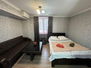 a living room with a bed and a couch at Guest House - Avlabari in Tbilisi City