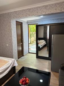 a bedroom with a mirror and a bowl of fruit on a table at Guest House - Avlabari in Tbilisi City