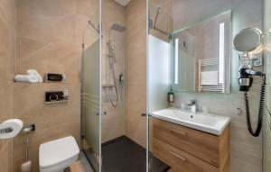 a bathroom with a shower and a sink and a toilet at Fashion City Hotel Superior in Budapest