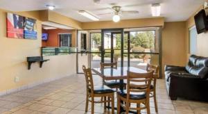 a living room with a table and chairs and a couch at Rodeway Inn & Suites in Lakeview