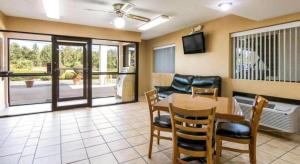 a dining room with a table and chairs and a television at Rodeway Inn & Suites in Lakeview