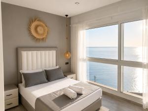 a bedroom with a large bed and a large window at Sensia Mediterranean Escape in Aouchtame +15 photos