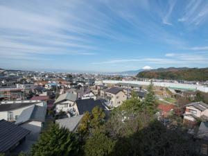 a view of a city with a mountain in the background at Suisenkaku in Numazu