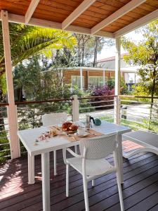 a white table and chairs on a wooden deck at Dune Prestige & Chalets in Bibione