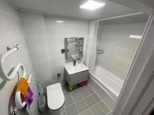 a bathroom with a toilet and a sink and a shower at Amarida residence in Erdenet
