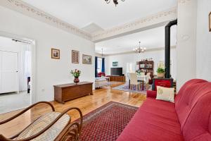 a living room with a red couch and chairs at Villa Balic in Gruda