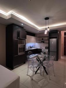 a kitchen with a glass table and chairs at The Residences at Crystal Towers in Cape Town