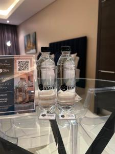 two empty glass bottles sitting on a glass table at The Residences at Crystal Towers in Cape Town +30 photos