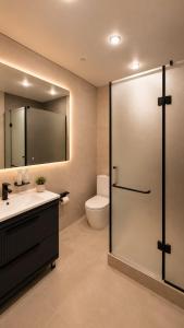 a bathroom with a toilet and a sink and a shower at Hotel Zerbulaq in Taraz