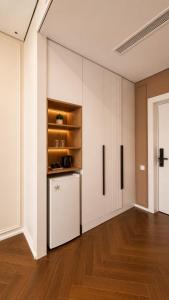 a kitchen with a white refrigerator in a room at Hotel Zerbulaq in Taraz