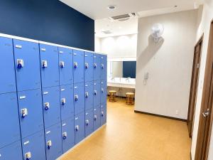 a locker room with blue lockers in a room at Matsue Universal Hotel in Matsue