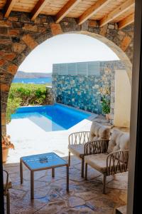 a patio with a view of a swimming pool at Apollonia Elounda View Villa in Elounda