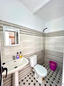 a bathroom with a white toilet and a sink at Relax in Oued Laou in Oued Laou +25 photos